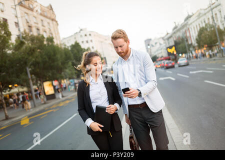 Businesspeople commuting and walking in city Stock Photo