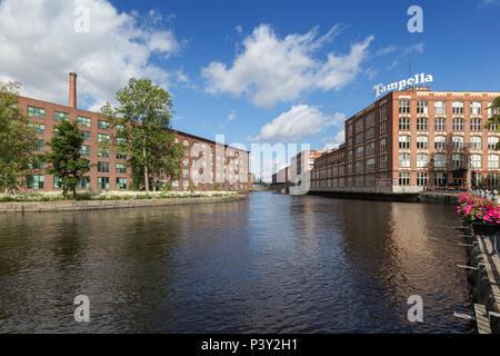 Old red brick industrial buildings along the Tammerkoski rapids in downtown Tampere, Finland on a sunny day. Stock Photo