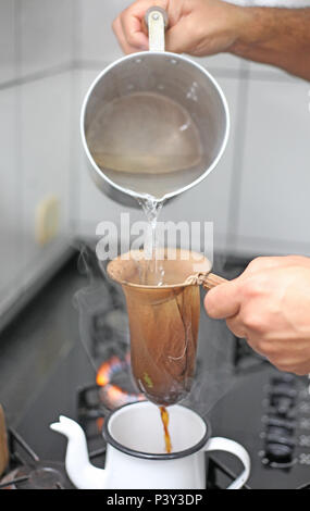 Preparo de café em coador de pano. Stock Photo