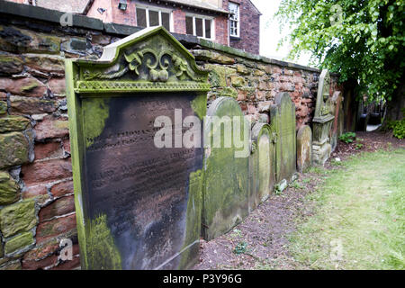 old historic gravestones in the churchyard grounds of St Cuthberts Church Carlisle Cumbria England UK Stock Photo