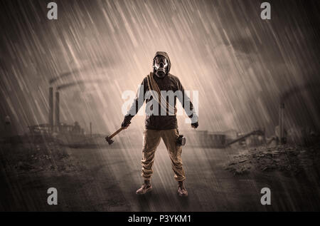 Gas masked survival man coming with arms on his hand  in a demolished dark environment   Stock Photo