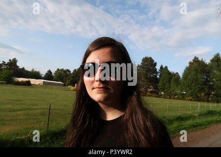 Portrait of bemused teenage girl with sunglasses Stock Photo