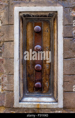 Old mechanical doorbell in Siena, Italy Stock Photo