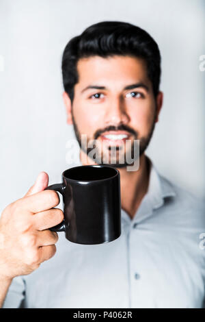 Arabic man in shirt with cup of coffee or tea Stock Photo