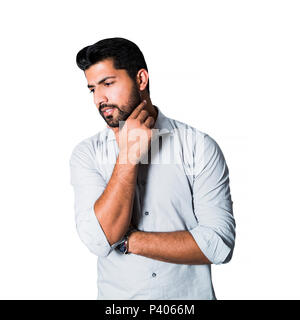 Pensive arabic man standing in white shirt Stock Photo
