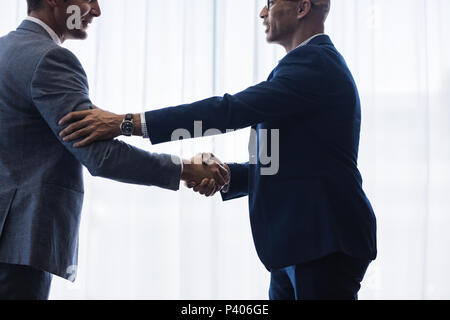 Businessmen hand shake after a deal in office. Businesspeople shaking hands and making an agreement. Stock Photo