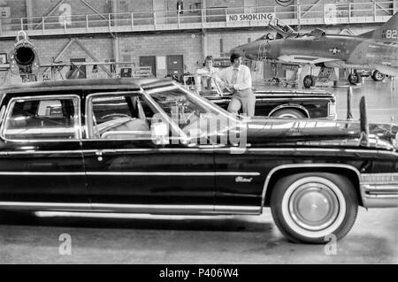 FORT SMITH, AR, USA - AUGUST 10, 1975 -- Two United States Secret Service agents keep watch  over the presidential limo in a secure military aircraft hanger while President Gerald Ford tours the new Vietnamese refugee center at Fort Chaffee, AR.  Focus is on the agents. Stock Photo