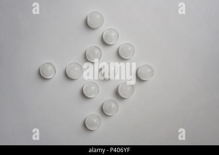 Spherical ice cubes arrow abstract composition isolated on white background from a high angle view Stock Photo