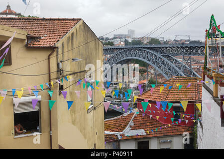 Dom Luís I Bridge (Ponte de Dom Luís) over the River Douro seen from the Escada dos Guindais, the stairs from Ribeira to Batalha in Porto, Portugal. The double-deck metal arch bridge designed by German engineer Théophile Seyrig was built in 1886. Vila Nova de Gaia is seen in the background. Stock Photo