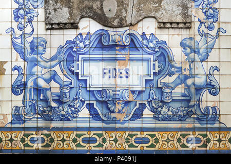 Putti depicted in the azulejo tiles painted by Portuguese painter Jorge Colaço (1932) on the main facade of the Church of Saint Ildefonso (Igreja de Santo Ildefonso) in Porto, Portugal. Fides means Faith in Latin. Stock Photo