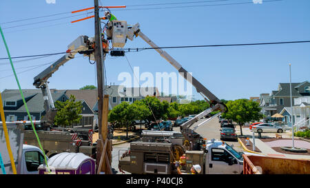 Sayreville NJ - June 15, 2018: Two workers in bucket truck doing construction work on power lines. Lineman for the Utility Companies Make Repairs to D Stock Photo