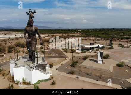 122/5000 Giant dancing statue Yaqui or dance of the deer of the indigena ethnic group in Sonora Mexico. Trubu Yaqui. Deer horns. Stock Photo