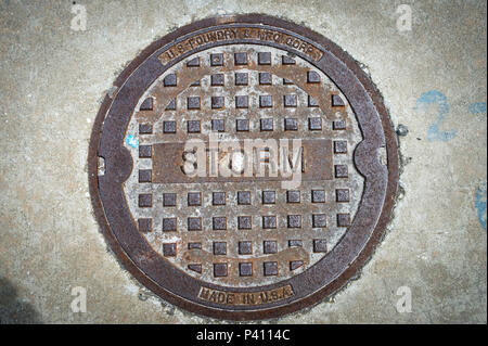 close up of a metal storm drain cover in the USA Stock Photo