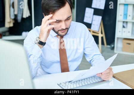 Brainstorming man reading papers Stock Photo