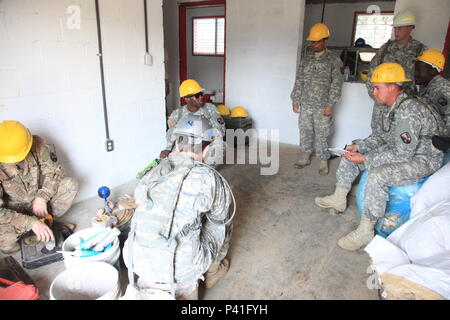 U.S. Army soldiers with 1021st Engineer Company, clean up the last little bit of material in the main area before moving on the next room, in Tocache, Guatemala, June 02, 2016. Task Force Red Wolf and Army South conducts Humanitarian Civil Assistance Training to include tactical level construction projects and Medical Readiness Training Exercises providing medical access and building schools in Guatemala with the Guatemalan Government and non-government agencies from 05MAR16 to 18JUN16 in order to improve the mission readiness of US Forces and to provide a lasting benefit to the people of Guat Stock Photo