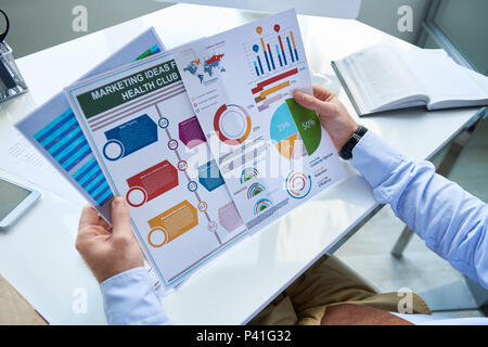 Crop businessman working with graphics Stock Photo