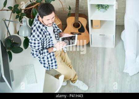Creative man with tablet in studio Stock Photo