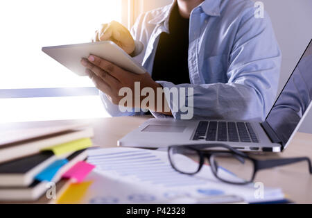 businessman using phone smart phone and notebook computer Stock Photo