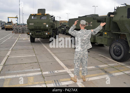 U.S. Army Staff Sgt. Jonathan Strout, of the 5th Battalion, 113th Field Artillery Regiment, North Carolina Army National Guard, guides a High Mobility Artillery Rocket Systems vehicle during convoy preparations at the port of Szczecin, Poland, during Exercise Anakonda 16 June 1, 2016.  AN16 is a Polish national exercise that seeks to train, exercise, and integrate Polish national command and force structures into an allied, joint, and multinational environment. (U.S. Army National Guard photo by Sgt. 1st Class Robert Jordan, North Carolina National Guard Public Affairs/Released) Stock Photo