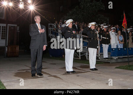From left, Dave Brandon, chief executive officer of Toys ‘R’ Us, U.S. Marine Corps Lt. Gen. Rex C. McMillan, commander of Marine Forces Reserve and Marine Forces North, and Col. Benjamin T. Watson, commanding officer of Marine Barracks Washington (MBW), salute during the evening parade at MBW, Washington, D.C., June 3, 2016. Evening parades are held as a means of honoring senior officials, distinguished citizens and supporters of the Marine Corps. (U.S. Marine Corps photo by Cpl. Samantha K. Draughon/Released) Stock Photo