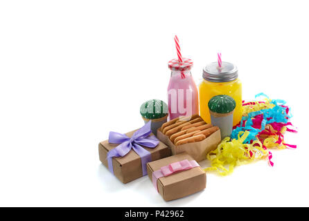 Decorative composition festive exotic cocktail on white background box with confetti gift satin ribbon. Natural drink in a glass mug Stock Photo