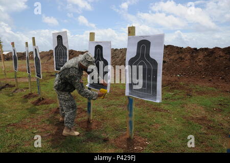 A member of the Florida Army National Guard sets up targets during the live fire training June 7 near Pearl Airport in Grenada during Tradewinds 2016. Tradewinds 2016 is a joint combined exercise conducted in conjunction with partner nations to enhance the collective abilities of defense forces and constabularies to counter transnational organized crime and to conduct humanitarian/disaster relief operations. Stock Photo