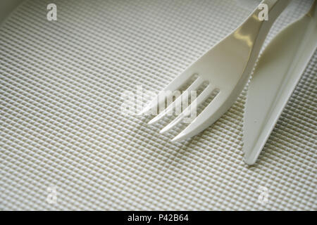 disposable plastic dishes, plate, fork, knife, cutlery Stock Photo