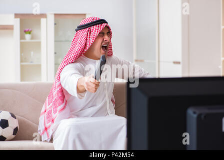 Arab businessman watching tv at home Stock Photo