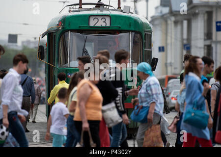 Yekaterinburg, Russia. 20th June, 2018. Soccer, World Cup 2018: Passers-by walk in front of a tram. Credit: Marius Becker/dpa/Alamy Live News Stock Photo