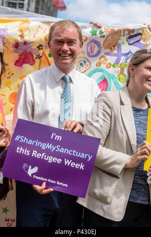 London, UK. 20th June, 2018.  Freedom from Torture holds a #sharingmysanctuary event in Parliament Square with a large banner with messages of welcome for refugees.Tim Faron MP supports the cause. Credit Ian Davidson/Alamy Live News. Credit: Ian Davidson/Alamy Live News Stock Photo