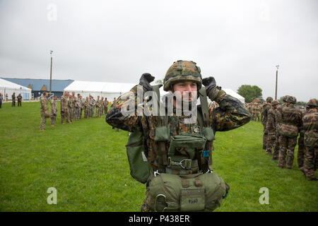 German jumpmasters deploy a parachute during sustained airborne training before airborne operations from a mock C-160 Transall during the 72nd Anniversary of D-Day, Sainte-Mere-Eglise, France, June 4, 2016. The Jump is conducted to commemorate the sacrifice of Soldiers during World War II, and to foster and nurture U.S. and German relationships, develop interoperability during training, and to provide a basis for future operations in training and real world environments. (U.S. Army photo by Spc. Tracy McKithern/Released) Stock Photo