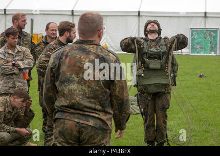 German jumpmasters deploy a parachute during sustained airborne training before airborne operations from a mock C-160 Transall during the 72nd Anniversary of D-Day, Sainte-Mere-Eglise, France, June 4, 2016. The Jump is conducted to commemorate the sacrifice of Soldiers during World War II, and to foster and nurture U.S. and German relationships, develop interoperability during training, and to provide a basis for future operations in training and real world environments. (U.S. Army photo by Spc. Tracy McKithern/Released) Stock Photo