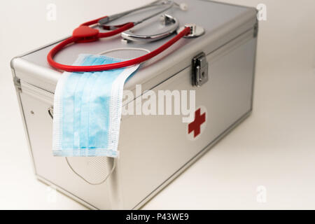 Anodised Aluminium First Aid Box, Surgeons Face Mask With Earloops and Stethoscope Stock Photo