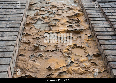 Old ruined yellow facade on a factory building Stock Photo