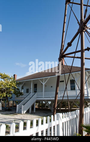 The lighthouse keepers house below the 98-foot tall iron Sanibel Island lighthouse, on a barrier island near Fort Myers, Florida. Stock Photo