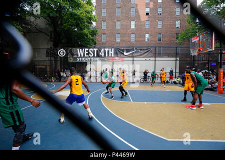 A West 4th Basketball tournament with a spectator view through a chain link fence in Greenwich Village, Manhattan, New York, NY. Stock Photo
