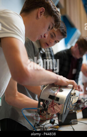 Students Nate Blanchard and Daniel Bannon work on a Remote Operated Vehicle during the 5th annual ROV Competition at Olympic High School, Bremerton, Washington. The event is sponsored by Naval Undersea Warfare Center Keyport and Puget Sound Naval Shipyard personnel to provide hands-on STEM education. Students design, assemble, and test ROVs to learn science, technology, engineering, and mathematics principles, while gaining practical experience in robotics and undersea vehicle operations. The program encourages interest in naval engineering and technology careers. Stock Photo