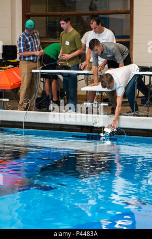 During the 5th annual ROV Competition at Olympic High School in Bremerton, Washington, student Daniel Bannon observes as Nate Blanchard places their Remote Operated Vehicle into the water for a buoyancy test. The competition, hosted by Naval Undersea Warfare Center Keyport and Puget Sound Naval Shipyard personnel, provides STEM-focused experiences. Students learn principles of physics, engineering, and technology while operating and testing underwater vehicles. The event encourages practical learning, teamwork, and interest in undersea systems and naval careers. Stock Photo