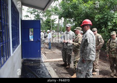 U.S. Army Staff Sgt. Randal Coggins, assigned to 1036 Sapper Company, (left) escorts Brig. Gen. Keith Klemmer the Arkansas deputy adjutant general, (center) through Catarina construction site, Guatemala, June 8, 2016. Task Force Red Wolf and Army South conducts Humanitarian Civil Assistance Training to include tactical level construction projects and Medical Readiness Training Exercises providing medical access and building schools in Guatemala with the Guatemalan Government and non-government agencies from 05MAR16 to 18JUN16 in order to improve the mission readiness of US forces and to provid Stock Photo