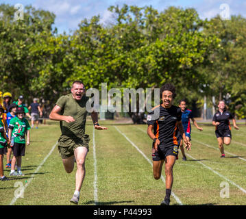 Lance Cpl. Ethan N. Fuller races a student during a sports day event at Alawa Primary School, Northern Territory, Australia, on June 10, 2016. U.S. Marines volunteer at the school as part of the School Mentorship Program. The program allows Marines to engage with and contribute to the local community during their six-month deployment in Darwin, Australia. Fuller, from Ashville, Alabama, is a field radio operator with 1st Battalion, 1st Marine Regiment, Marine Rotational Force – Darwin. (U.S. Marine Corps courtesy photo/Released) Stock Photo