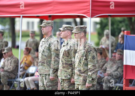 (From left to right) U.S. Army Lt. Col. Peter B. Wilson, the 44th Expeditionary Signal Battalion (44th ESB) outgoing Commander, U.S. Army Col. Ed Buck, the 2nd Signal Brigade Commander, and U.S. Army Lt. Col. Adam A. Sannutti, the 44th ESB incoming Commander, stand in front of the formation during the Battalion’s Change of Command Ceremony at the Tower Barracks Parade Field, Grafenwoehr, Germany, Jun. 10, 2016. (U.S. Army photo by Visual Information Specialist Gertrud Zach/released) Stock Photo