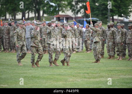 (From left to right, saluting) U.S. Army Lt. Col. Adam A. Sannutti, the 44th Expeditionary Signal Battalion (44th ESB) incoming Commander, U.S. Army Lt. Col. Peter B. Wilson, the 44th ESB outgoing Commander, and U.S. Army Col. Ed Buck, the 2nd Signal Brigade Commander, inspect the soldiers in formation during the Battalion’s Change of Command Ceremony at the Tower Barracks Parade Field, Grafenwoehr, Germany, Jun. 10, 2016. (U.S. Army photo by Visual Information Specialist Gertrud Zach/released) Stock Photo
