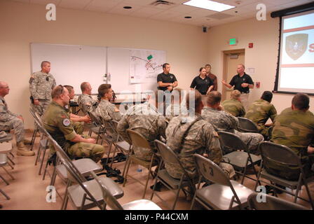 Washington County SWAT Team Crisis Negotiator Chris Rheault explains his first-hand account of a hostage negotiation while providing training at Camp Ripley June 24. During the training Soldiers of the Minnesota National Guard and the Norwegian Home Guard received training from local Minnesota law enforcement officers during a three-day domestic operations training event held at Camp Ripley. (Minnesota National Guard Photo by Master Sgt. Ashlee J. L. Sherrill) Stock Photo