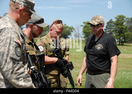 Soldiers of the Minnesota National Guard and the Norwegian Home Guard receive training from local Minnesota law enforcement officers during a three-day domestic operations training event held at Camp Ripley June 24-26. The Soldiers ran through a number of drills including reacting to active shooters, hostage rescue and basic room clearing procedures. (Minnesota National Guard Photo by Master Sgt. Ashlee J. L. Sherrill) Stock Photo