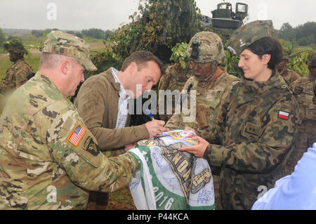 Secretary of the Army, Hon. Eric Fanning signs an Exercise Anaconda 2016 flag while visitng US troops participating in the exercise in Drawsko Pomorskie, Poland.  a Polish-led, multinational exercise running from June 7-17, involves approximately 31,000 participants from more than 20 nations and is a premier training event for U.S. Army Europe. Stock Photo