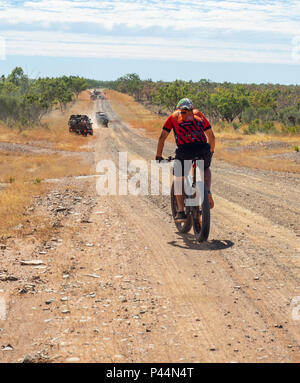 Gibb Challenge 2018 a cyclist in Jersey and bib riding a fatbike on dirt road Gibb River Road Kimberley Australia Stock Photo