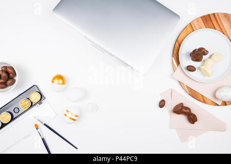 Happy Easter. Stylish stationery background with chocolate eggs. gold and white eggs and accessories on white background. Table decorating for holiday Stock Photo