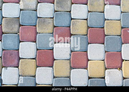 Multi-colored paving slabs in the form of bricks in the form of a background. Stock Photo