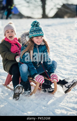 two little girls in sportswear sitting at fitness studio, children