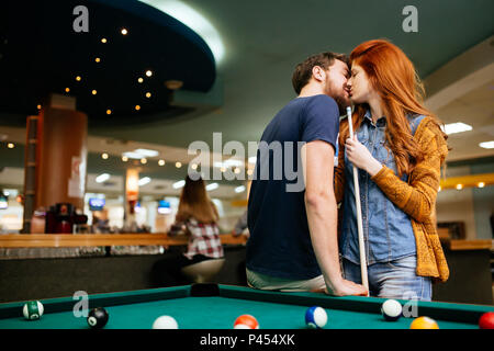 Beautiful couple kissing in billiards bar Stock Photo